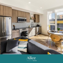a living room and kitchen with furniture and large windows