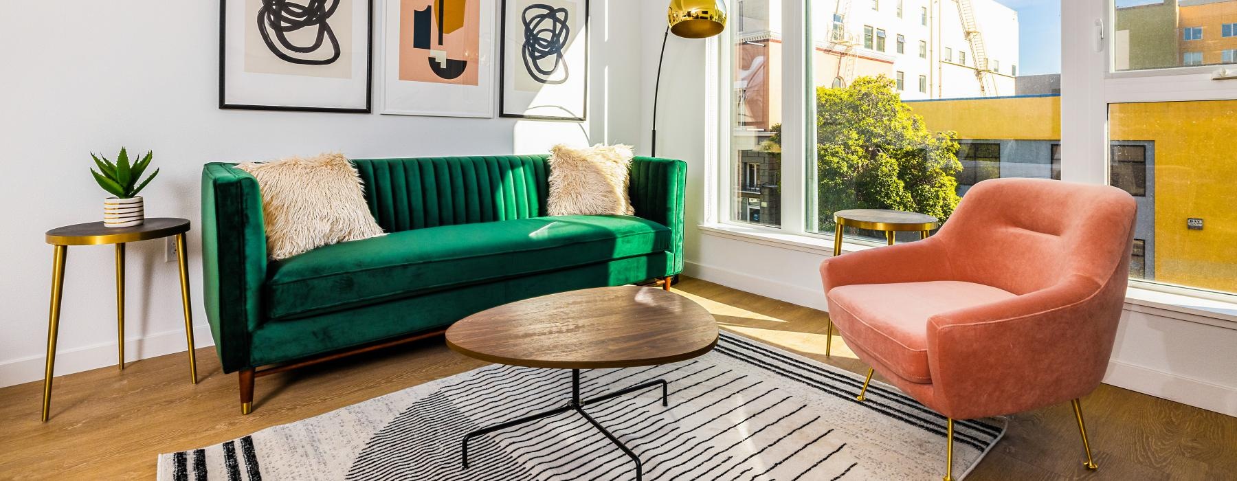 furnished living room with large windows offering city views